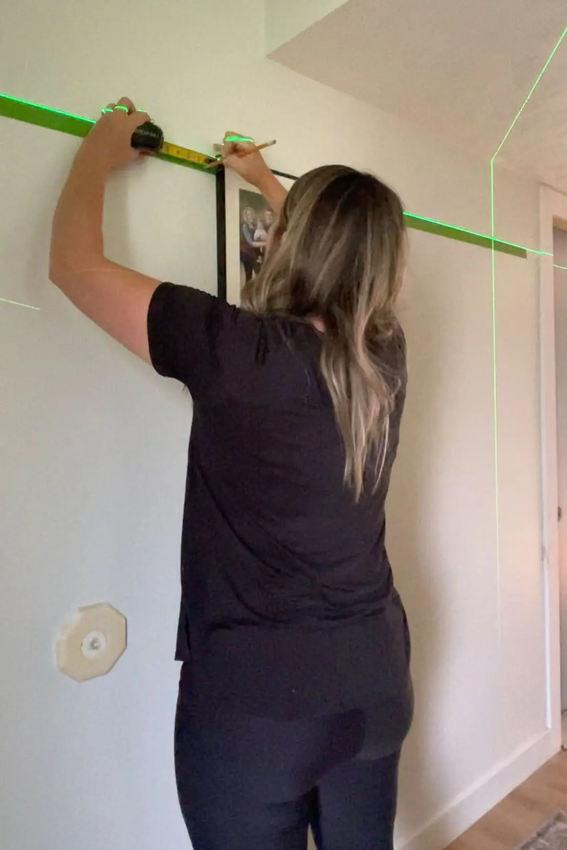 Measuring for hanging a gallery wall layout. 